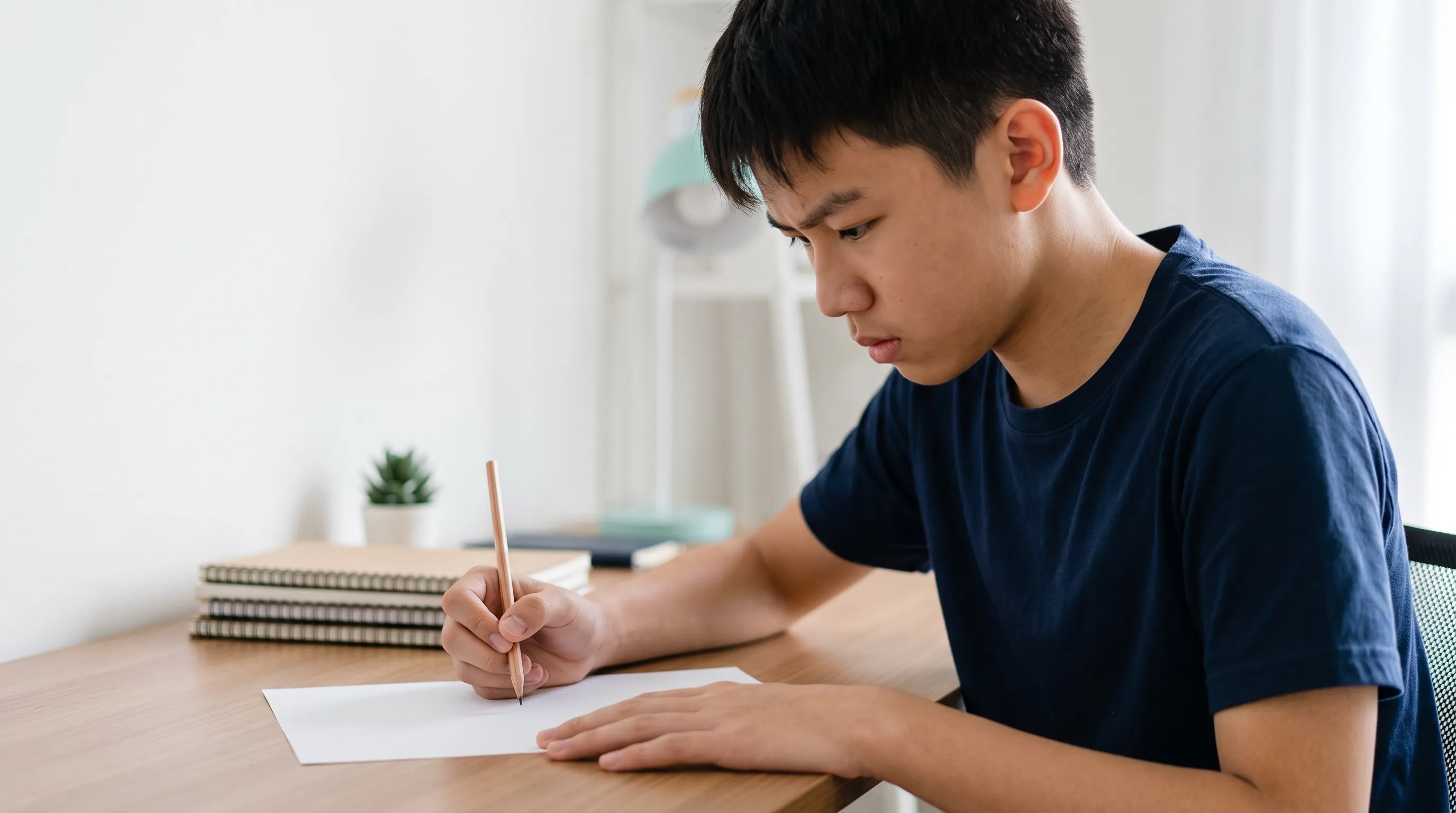 Student writing notes during a lesson